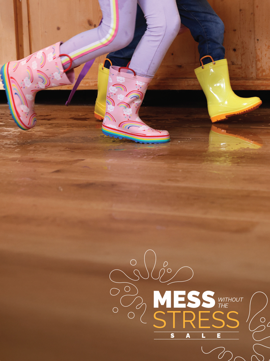 Mom and daughter playing with tablet on hard surface floor